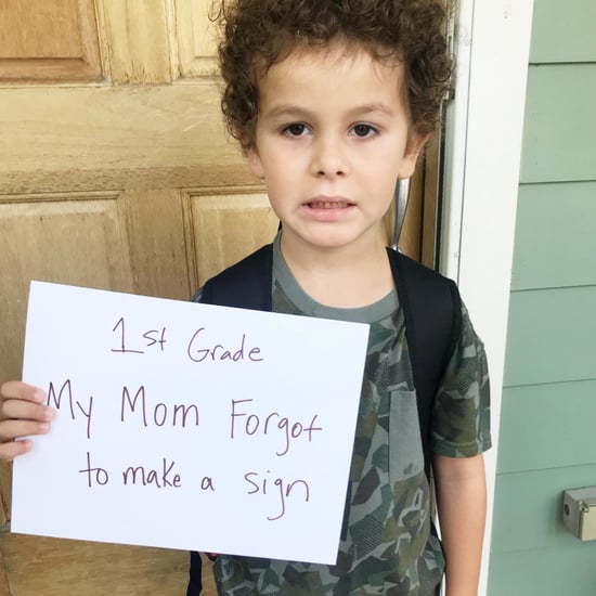 Boy Holding Lazy Version of First-Day-of-School Sign