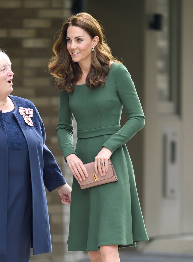 Kate Middleton stepped out for her first royal engagement of the new month on Wednesday, when she opened the new Anna Freud National Centre for Children and Families in London. For the occasion, the duchess turned to one of her favorite designers, Emilia Wickstead, opting for a dark green long-sleeved dress with a flippy hem and a built-in belt. It may be a familiar style for the duchess, as it's got a lot in common with a chic Beulah London dress she wore in February, but it looks like this is a brand new addition to her wardrobe. 

    Related:

            
            
                                    
                            

            Kate Middleton Adds Another Coat to Her Collection as She Steps Out With Prince Harry
        
    
Rather than matching the dress with accessories, Kate added a springlike touch by finishing her look with contrasting beige shoes and a clutch. The suede pumps were by Gianvito Rossi, while the clutch was a Mulberry Amberley. The duchess has worn this combo before, notably last November when she added them to a royal blue Jenny Packham dress. This time around, she finished the ensemble with a pair of drop earrings from one of her most frequently worn jewelry designers, Kiki McDonough. Keep reading to see the look from all angles ahead.