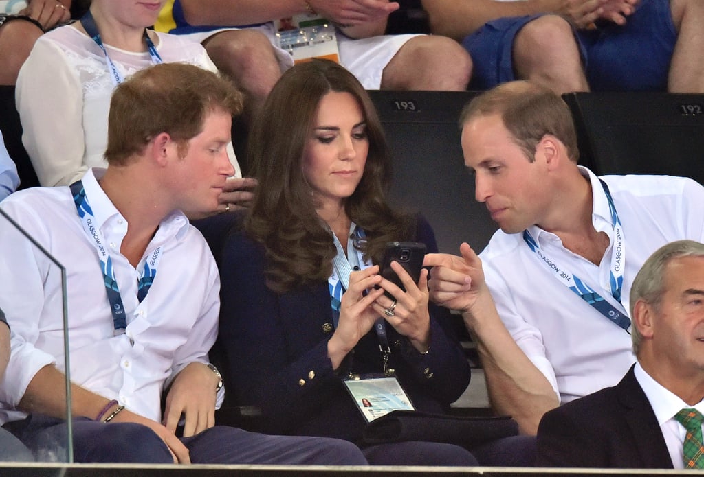 Kate showed Harry and William something on her phone during Monday's games.