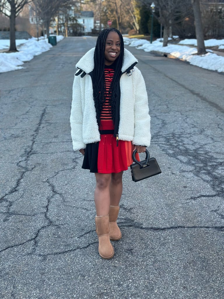 "I have to admit I was hesitant to embrace UGGs when I first discovered them in the early 2000s; I was still in my wearing-heels-every-day era and couldn't fathom rocking an oversize pair of flat boots just for comfort. One day, my best friend who worked at Nordstrom (in our local mall!) convinced me to try them on, and everything changed. They felt like pillows for my feet and I simply couldn't turn that down. Imagine my surprise and delight when I saw people styling them with skirts and dresses, proving fashion and function could live in harmony. 
Now, more than 20 years later, I style the UGG Classic Short II ($190) like they're heels with my favorite pleated miniskirt and striped sweater from YanYan, an oversize DKNY fleece jacket, and my treasured Luar bag. As the 2000s style icons — from Beyoncé to Nicole Richie — proved, UGGs can and should be dressed up!" — Jessica Andrews, senior style director