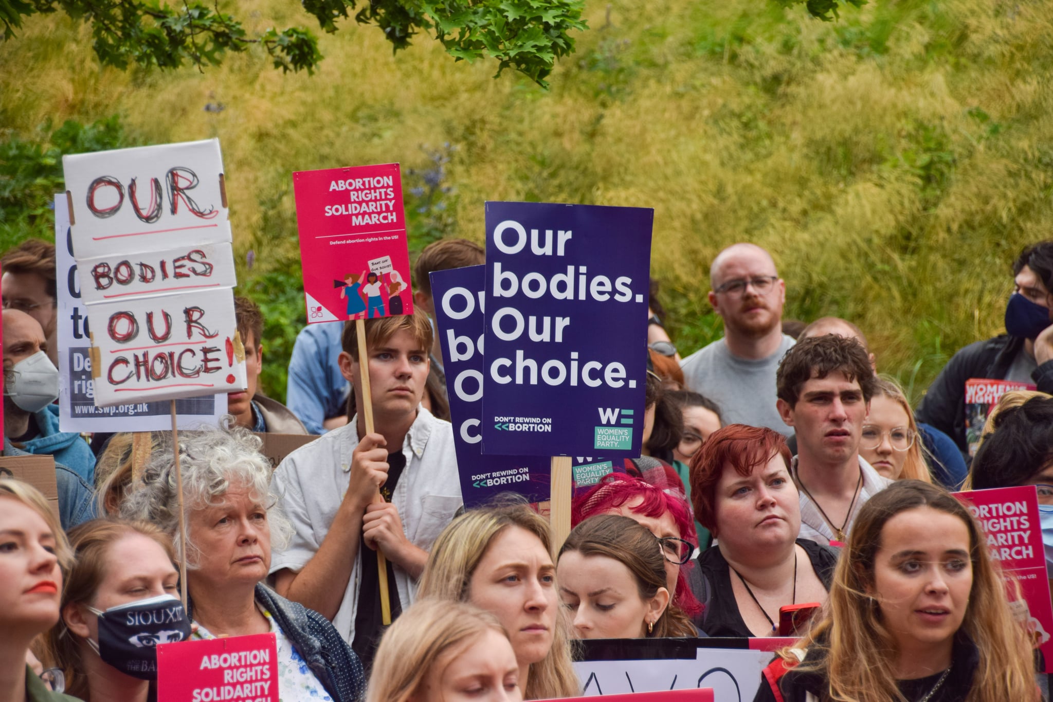 LONDON, UNITED KINGDOM - 2022/06/24: A woman holds a placard that says, 