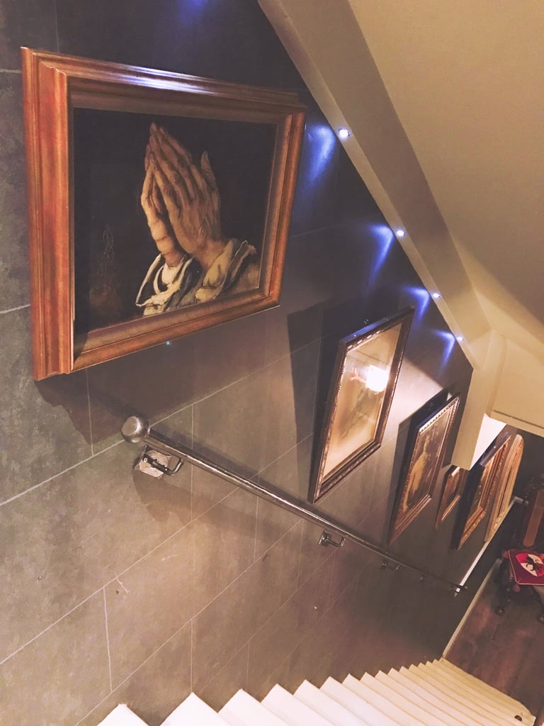 Here's the hallway down to The Wizarding Chambers, which is the bigger Harry Potter-inspired suite for families or groups. I could have sworn the paintings were moving! 
All in all, I'd say it was a fun, unique experience, and I'm glad we did it. I loved all the little details inspired by the series, and it did a good job of feeling like Hogwarts without be overtly HARRY POTTER. I also firmly believe all hotels (in the UK but really worldwide) should provide the complete Harry Potter film series. The room we stayed in, however, was pretty small and poorly laid out for the price, so I probably wouldn't do it again unless we had more people and could stay in The Wizarding Chambers.