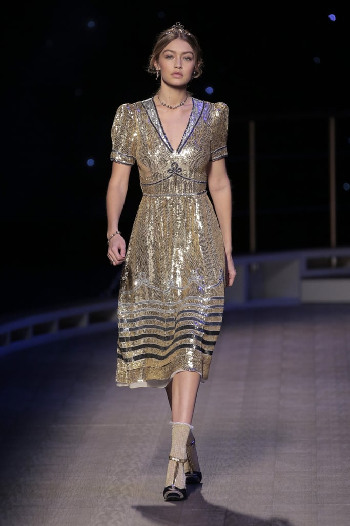 Gigi closed the Tommy Hilfiger show in a sequined gold lamé sailor dress, metallic T-strap pumps, and a matching choker. Her standout look was certainly finale worthy.