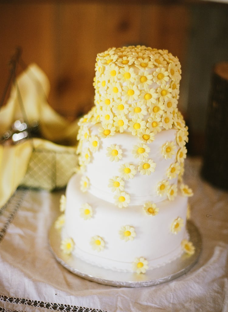 What better way to leave a lasting impression than with bright cascading daisies on a cake?