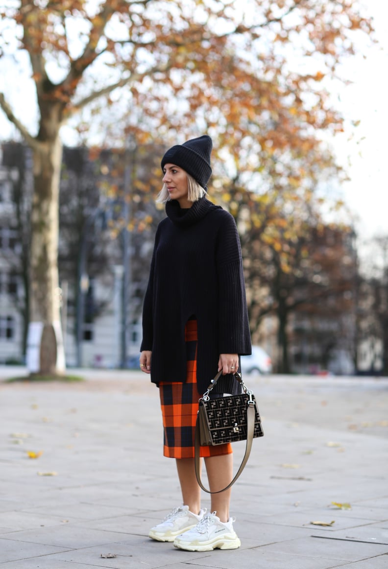 Get Preppy in a Plaid Wool Skirt, Oversize Turtleneck, and White Sneakers