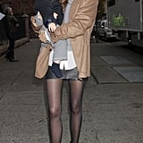 Adding a warm, camel blazer to her black mini, she gave the skirt modern sophistication — and made it look easy.