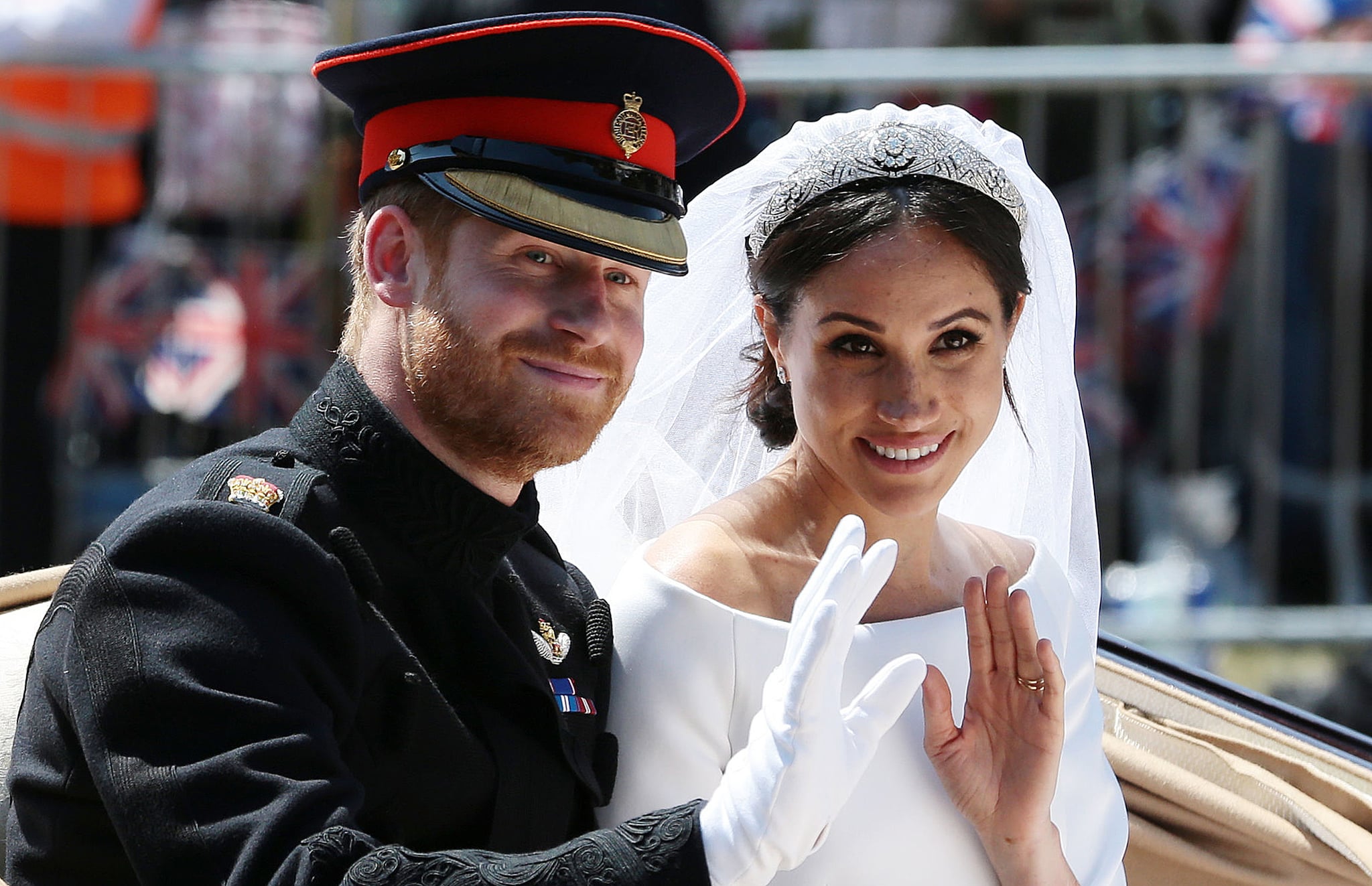 Britain's Prince Harry, Duke of Sussex and his wife Meghan, Duchess of Sussex wave from the Ascot Landau Carriage during their carriage procession on the Long Walk as they head back towards Windsor Castle in Windsor, on May 19, 2018 after their wedding ceremony. (Photo by Aaron Chown / POOL / AFP)        (Photo credit should read AARON CHOWN/AFP/Getty Images)