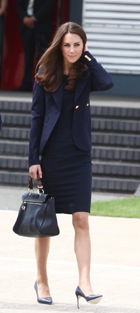 Kate Middleton in a blue sheath dress and blazer leaving the UK for Canada in June 2011.