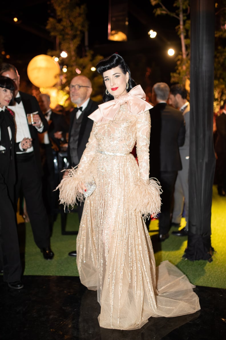 Dita Von Teese Wore a Gold Elie Saab Gown With Feathered Sleeves and a Giant Bow