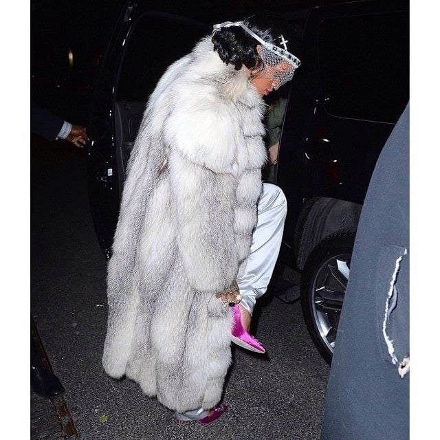 The singer topped her suit off with a gigantic white fur coat, a white veil, and pink shoes.
Source: Instagram user badgalriri