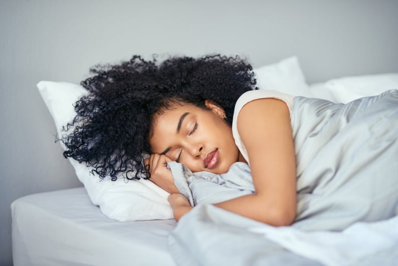 Shot of a young woman sleeping peacefully in her bed