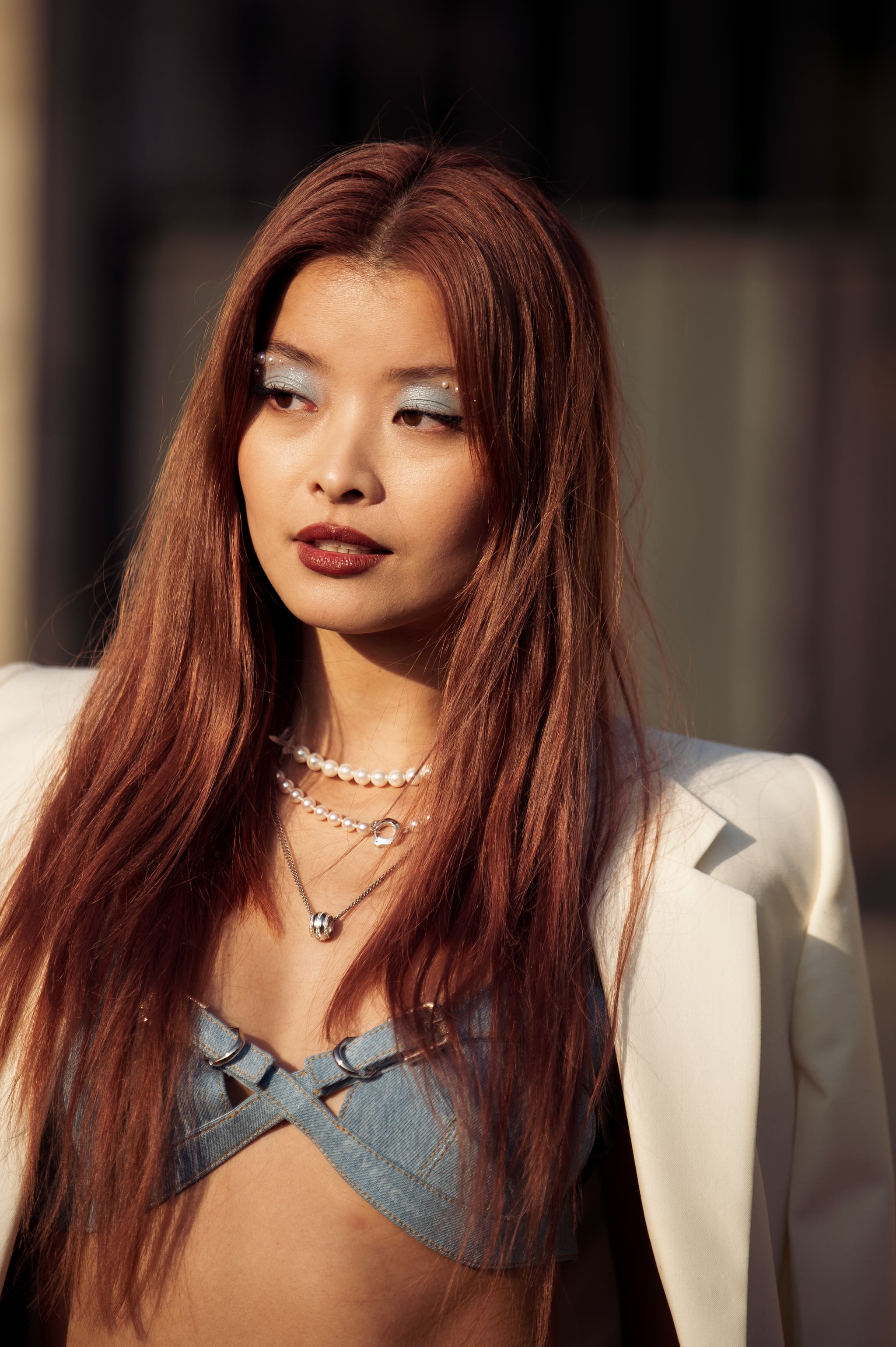 PARIS, FRANCE - MARCH 02: Caroline Hu is seen wearing a cream jacket, blue bralette, blue pearl jeans and white and gold chain Givenchy bag outside the Givenchy show during Paris Fashion Week - Womenswear Fall Winter 2023 2024, on March 02, 2023 in Paris, France. (Photo by Raimonda Kulikauskiene/Getty Images)