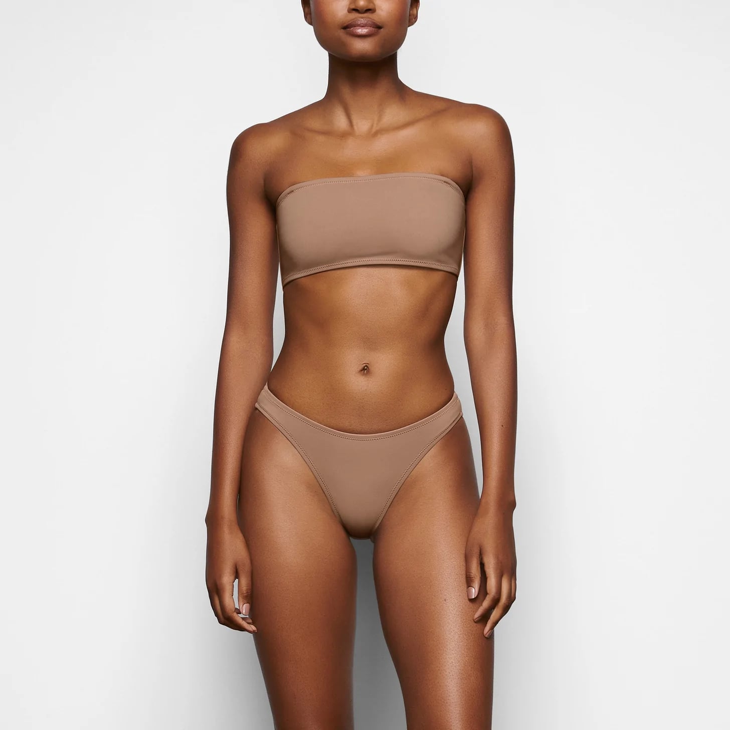 SKIMS on X: The Cotton String Bikini features a second-skin design that is  effortlessly and universally flattering. Shop now at   and enjoy free shipping on domestic orders over  $75.  /
