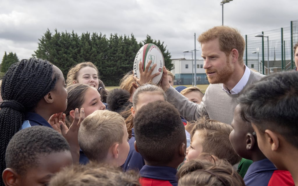 Prince Harry Hugs Kids at Lealands High School