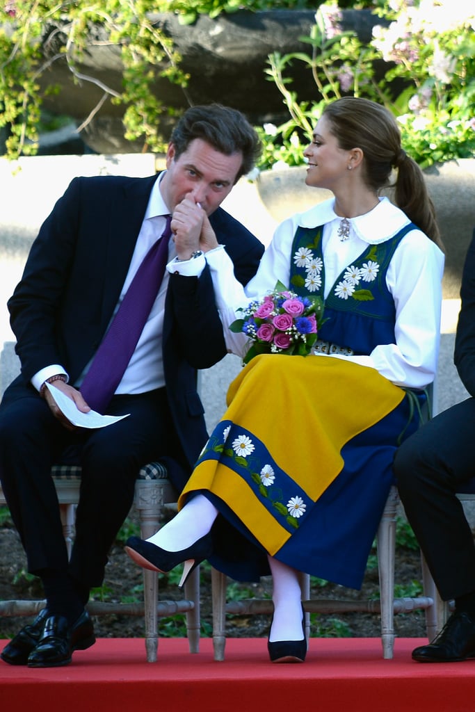 Madeleine's husband gave her a kiss on Sweden's national day — hence her traditional costume.
