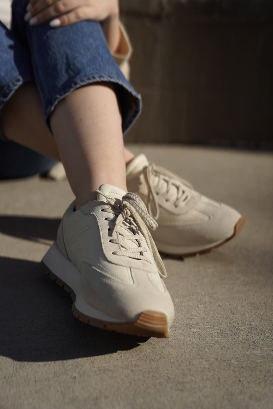 woman wearing Koio Retro Runner Sneakers in Cloud