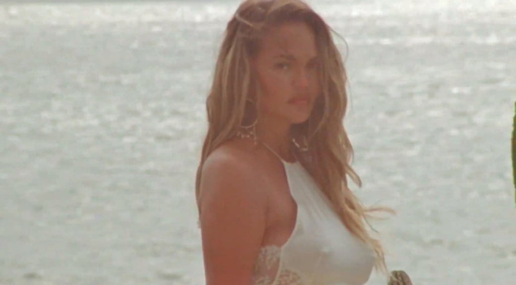 Chrissy Teigen Reveals Pregnancy in a White Dress in "Wild"