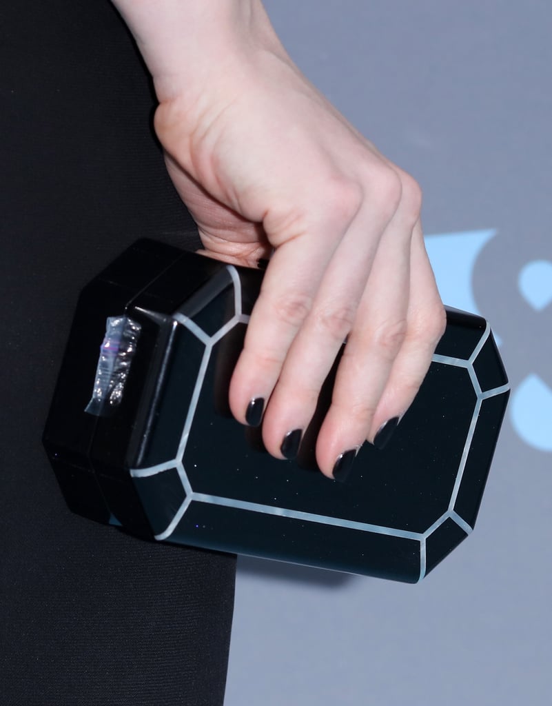 Then she completed the dark look with an Edie Parker clutch.