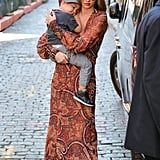 While on mommy duty, Miranda donned a paisley print maxi dress by Skaist Taylor with studded sandals and aviator sunglasses.