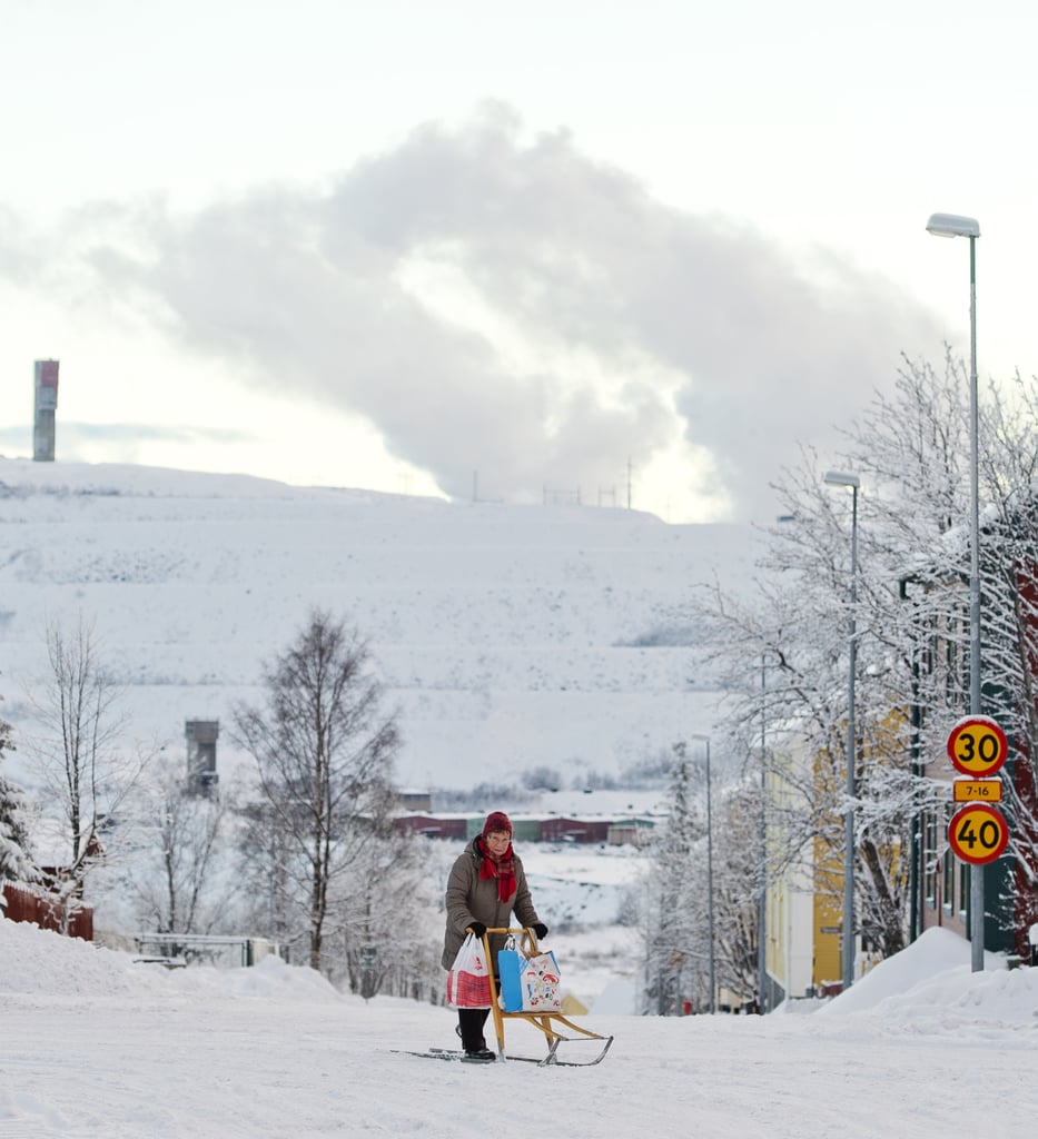 A woman rode her sled along a snowy road in Sweden.