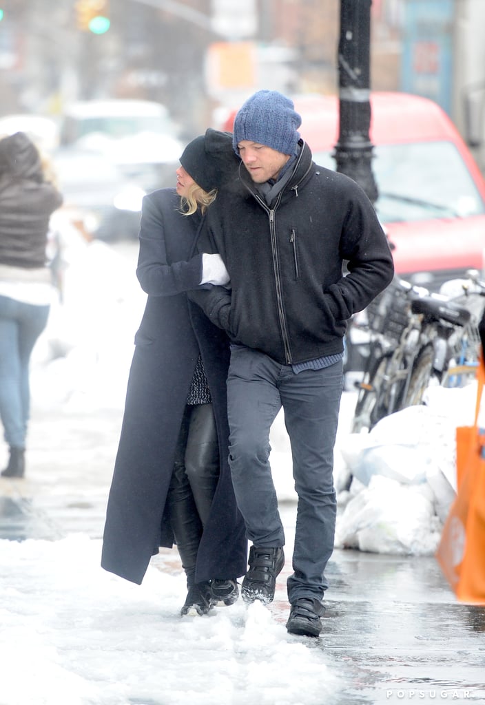 Lara Bingle and Sam Worthington tried to keep warm while taking a Wednesday stroll.