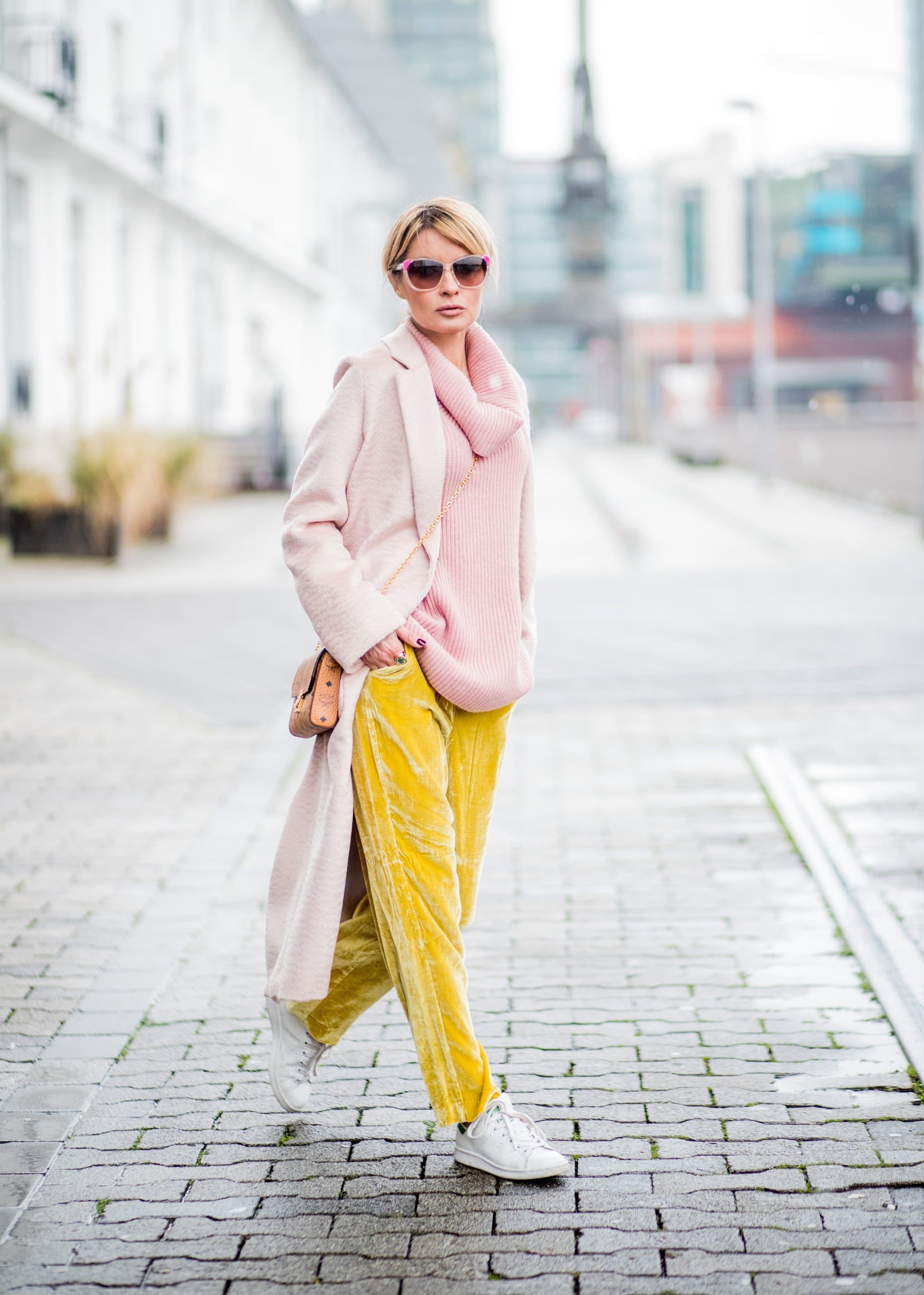 With a Pink Jumper Yellow Velvet Trousers and a Light Pink Coat