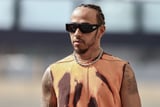 Lewis Hamilton’s Paddock Style Includes Sequins, Bucket Hats, and Boob-Windows