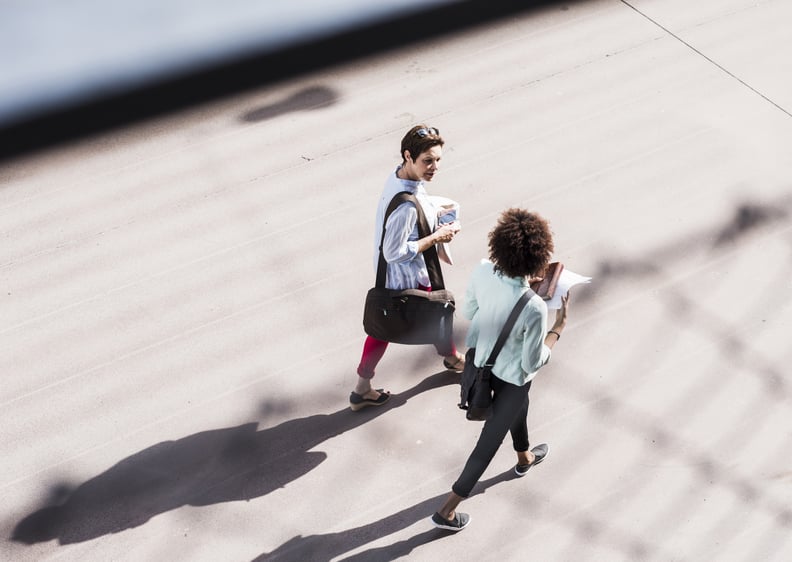 two women colleagues walking