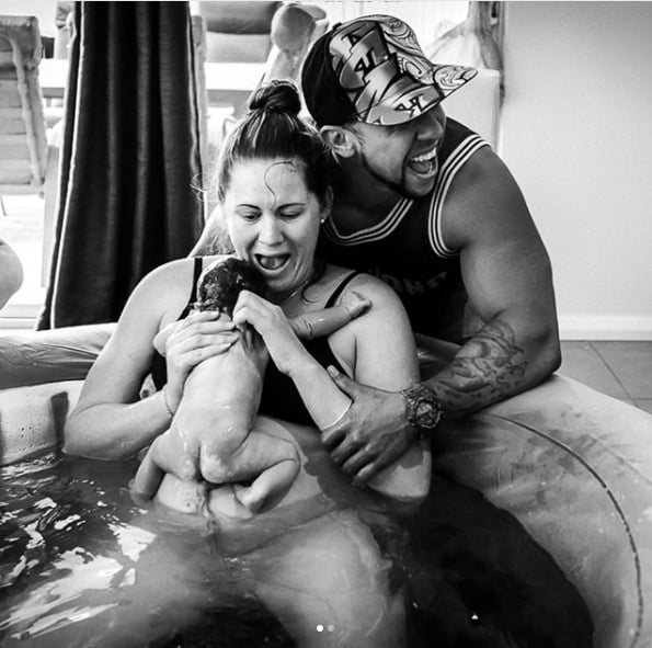 This mom's relief and happiness is written all over her face as she lifts up her baby.