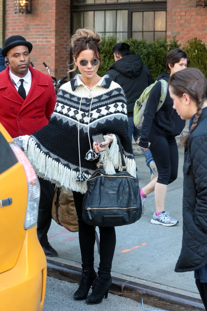 She kept warm in a printed poncho and accessorized with the Givenchy Pandora bag.