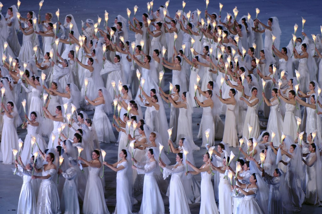 White maidens carried lit-up lilies while forming the "Dove of Peace."