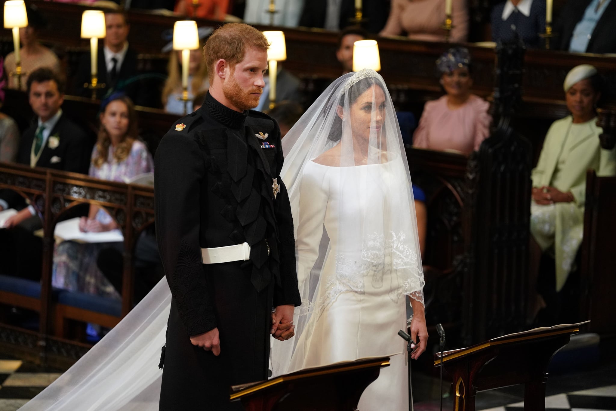 Britain's Prince Harry, Duke of Sussex (L) and US fiancee of Britain's Prince Harry Meghan Markle stand together for their wedding in St George's Chapel, Windsor Castle, in Windsor, on May 19, 2018. (Photo by Dominic Lipinski / POOL / AFP)        (Photo credit should read DOMINIC LIPINSKI/AFP/Getty Images)