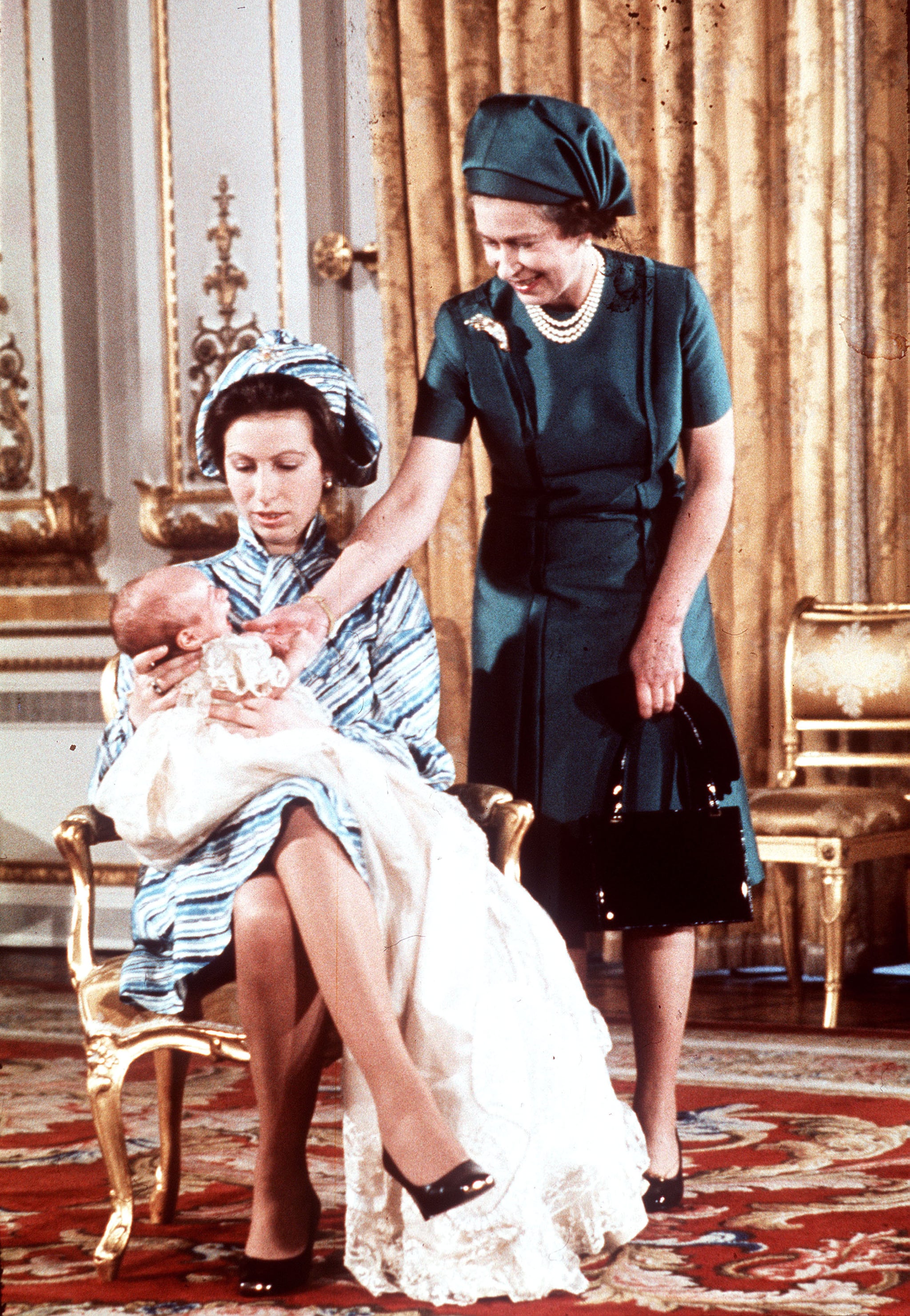 Queen Elizabeth II (right) with Princess Anne and Peter Phillips in 1977