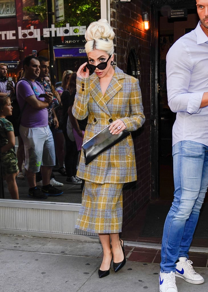 Peeking at the paparazzi wearing a patterned suit by Calvin Luo.