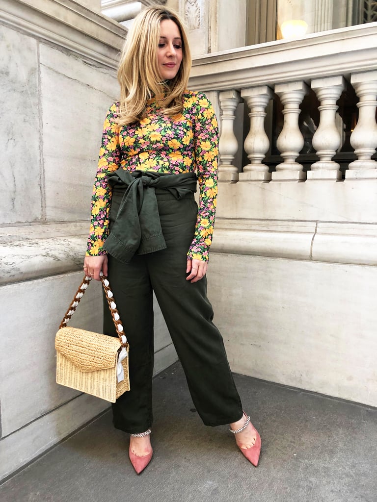 One of the best features of a boilersuit is the versatility, so I got creative and styled mine like pants on my second go — I did this by folding the suit down and tying the sleeves around my waist. Willing Spring my way but staying warm, I mixed in a thin floral print turtleneck, structured straw bag, and crystal-adorned mules in pink suede (I also wore the cutest gold mobile earrings, but alas, my hair took center stage). While this look is far outside my comfort zone, the feminine twist felt fresh, comfortable, and super fun for Spring. 
On Laura: POPSUGAR at Kohl's utility suit, Maje turtleneck, Jimmy Choo mules, Pamela Munson bag, Zoë Chicco earrings.