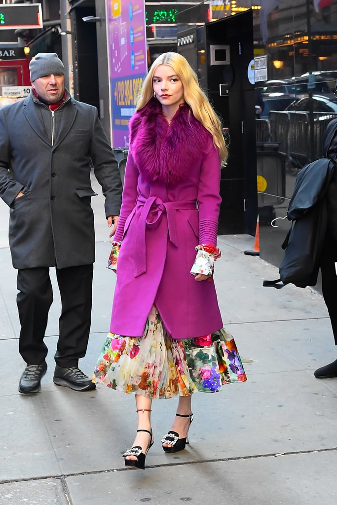 Anya played up the magenta blooms on her pleated dress with this furry-collared coat in NYC. And how could we skip over her accessories: hoop earrings, embellished buckle platforms, and a beaded anklet.