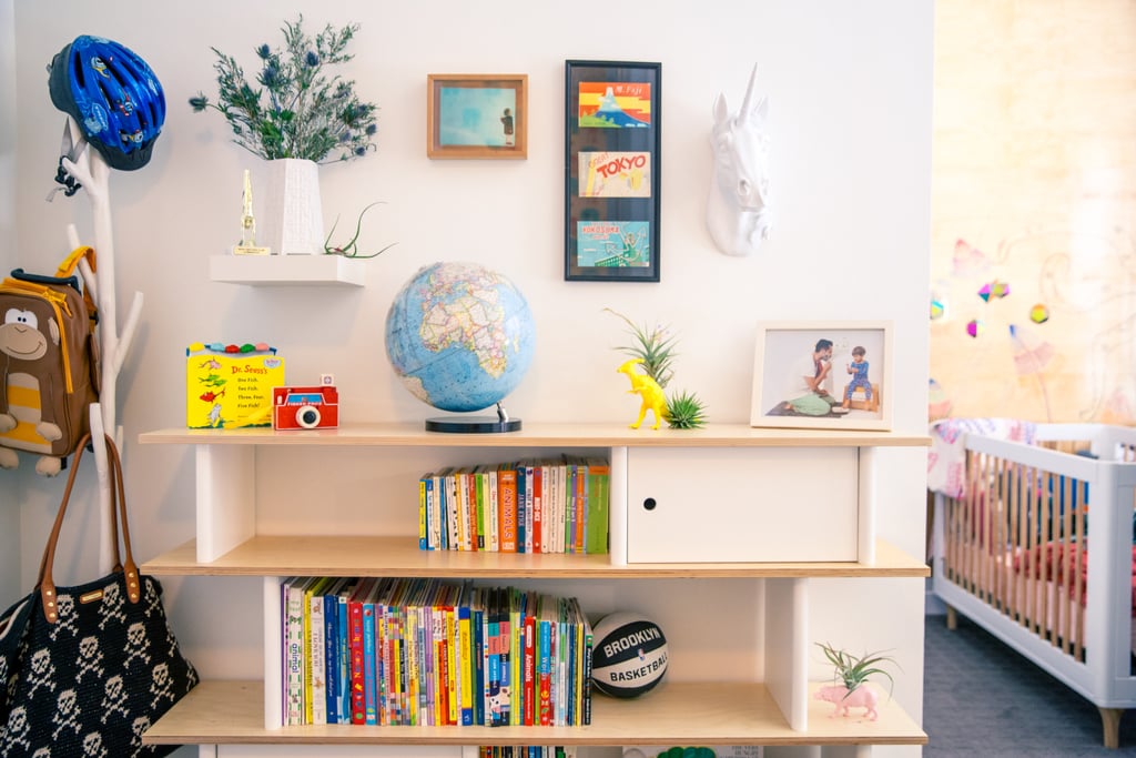 A faux-taxidermy unicorn ($85) hangs over the bookshelf, which also holds a Brooklyn Nets basketball to show off some hometown pride.