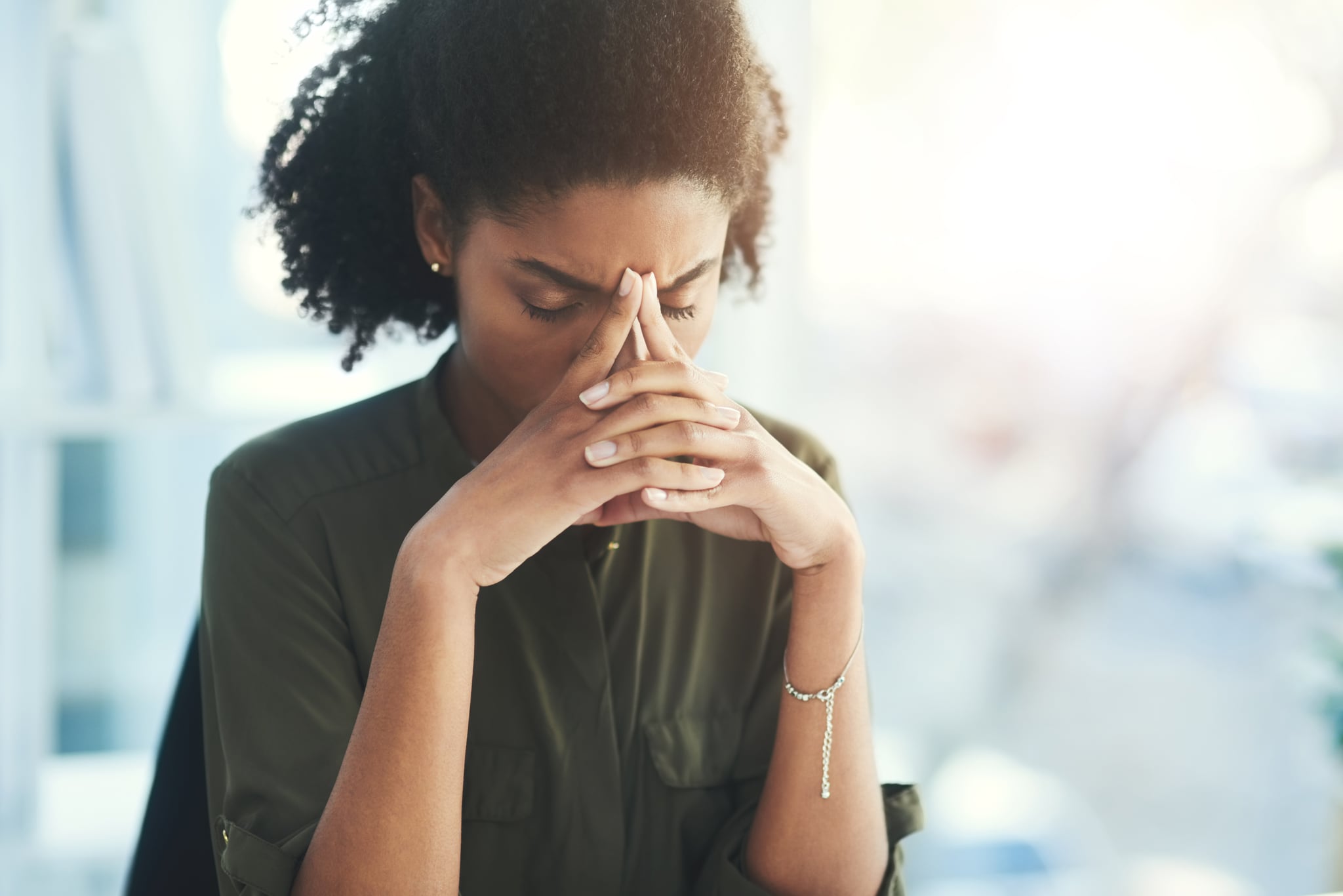 Shot of a young businesswoman looking overly stressed in her office