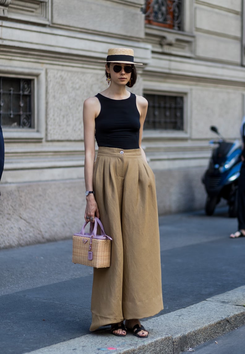 Team with a straw hat, styling high-waisted trousers and a simple top.