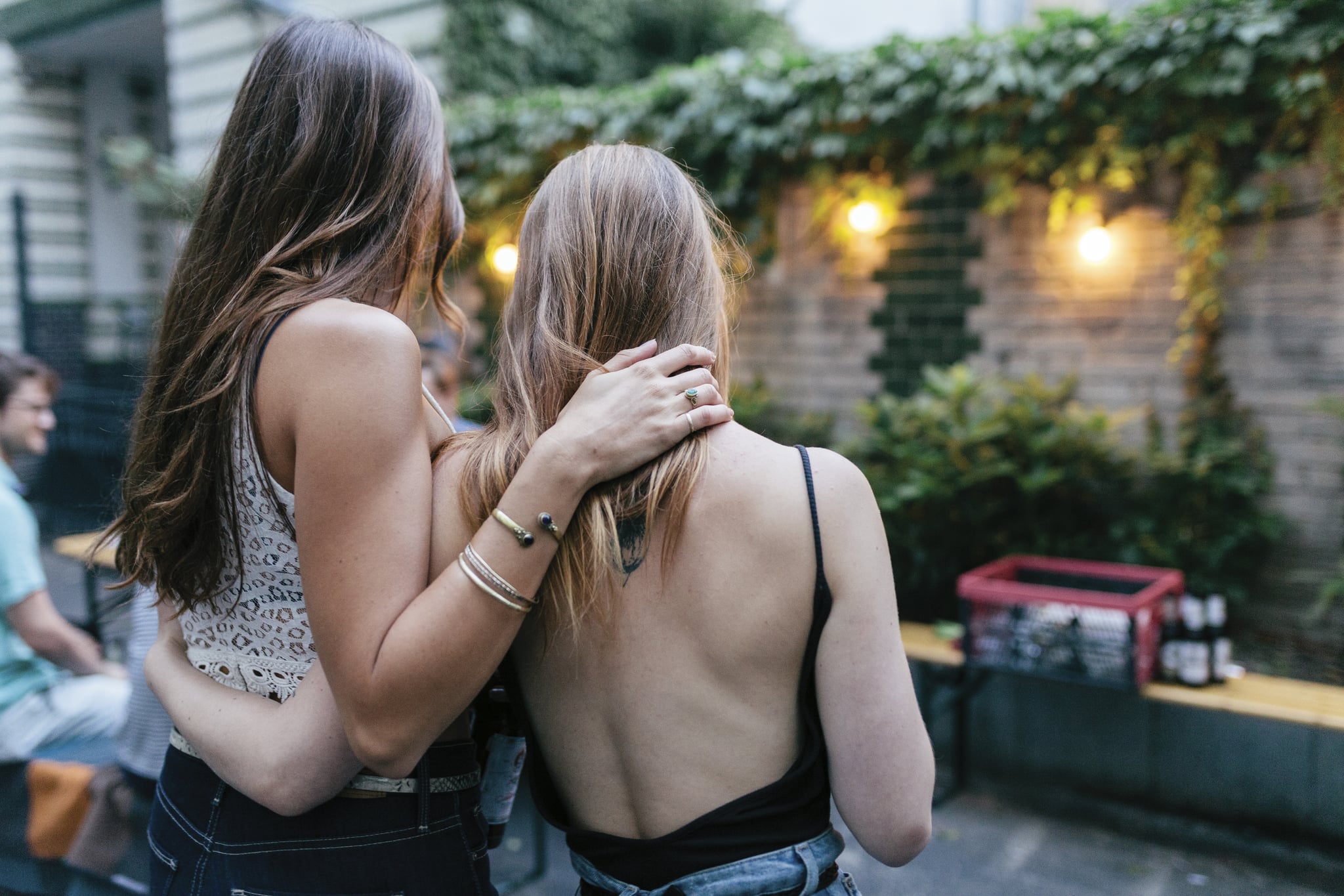 Two Friends Embracing While Waiting For Barbecue To Warm Up