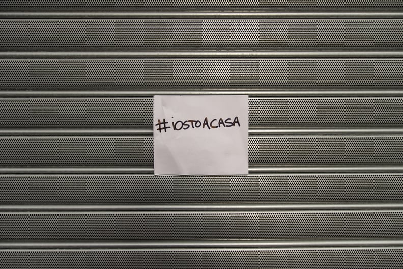 SALERNO, ITALY - MARCH 10: The shutter of a shop closed with a sign that reads #iorestoacasa (I'm staying at home) on March 10, 2020 in Salerno, Italy. In Italy after the extension of the red zone to the entire peninsula due to the spread of the coronavir