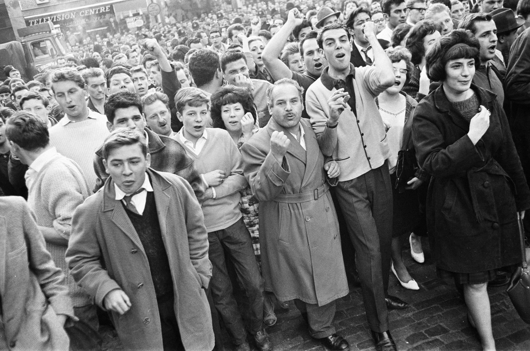 Ridley Road, London, Tuesday 31st July 1962: A large crowd gathers in the East End to disrupt a rally by former fascist leader Sir Oswald Mosley and members of his anti-Semitic Blackshirt group who had planned a rally in London's East End. Mosley and his group were assaulted and punched to the ground as soon as his meeting opened at Ridley Road, Dalston. Police closed the meeting within the first three minutes and made 54 arrests, one of which was Sir Oswald's son Max. (Photo by Bob Powell/Don Smith/Mirrorpix/Getty Images)