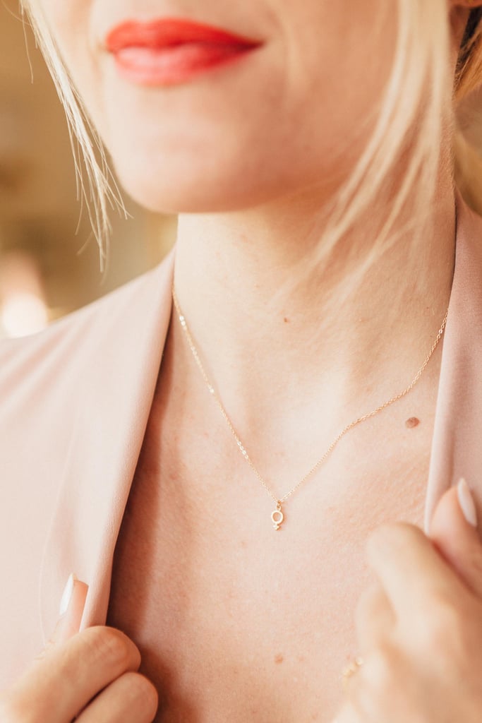 Hey, ladies, wear it loud and proud and fine-gold classy with the Katie Dean Jewelry Female Symbol Necklace ($55).