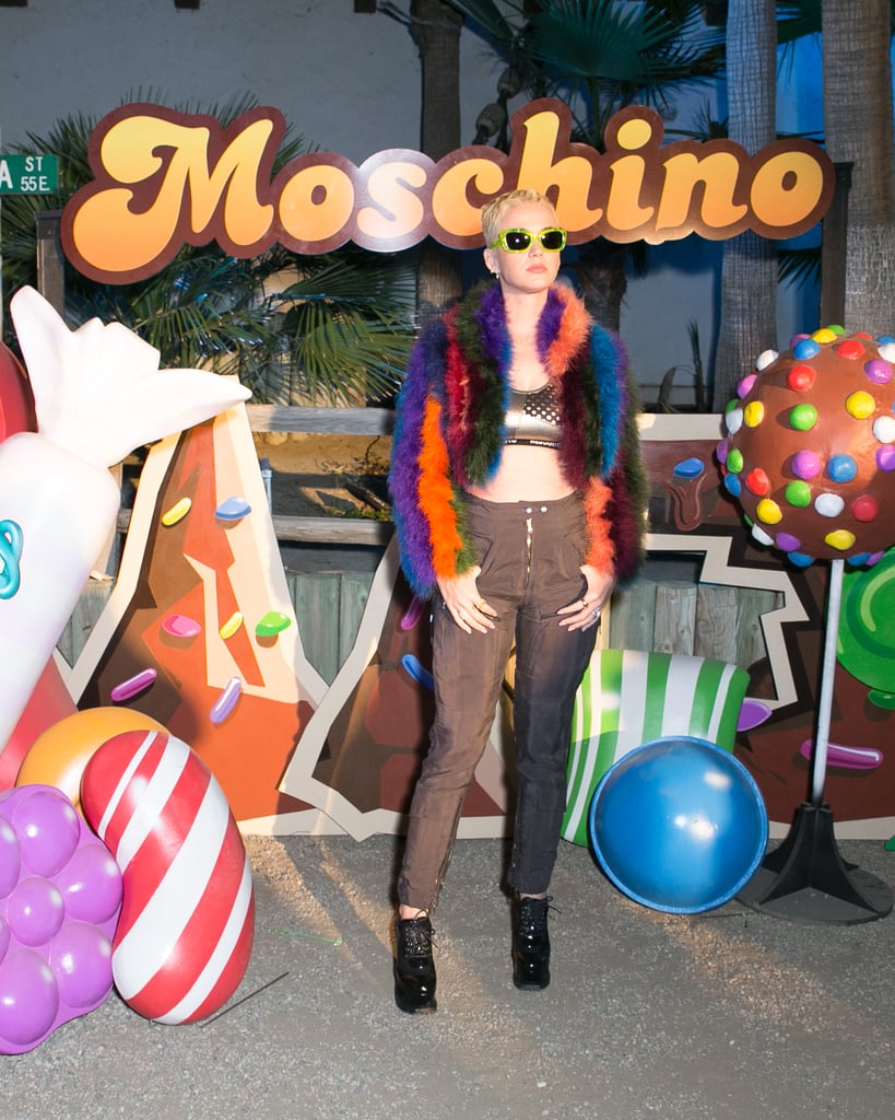 Katy Perry wearing high-waisted jeans and a furry rainbow coat at the Moschino x Candy Crush Desert party. 
