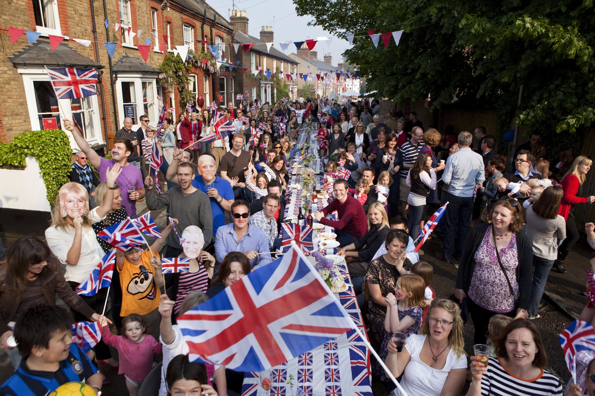 BERKHAMSTED, UNITED KINGDOM - APRIL 29:  Residents at a Royal Wedding Street Party celebrate the marriage of Prince William and Catherine Middleton, in Chapel Street in Berkhamsted on April 29, 2011 in Berkhamsted, England. The marriage of Prince William, the second in line to the British throne, to Catherine Middleton is being held in London today. The Archbishop of Canterbury conducted the service which was attended by 1900 guests, including foreign Royal family members and heads of state. Thousands of well-wishers from around the world have also flocked to London to witness the spectacle and pageantry of the Royal Wedding and street parties are being held throughout the UK. (Photo by David Levenson/Getty Images)