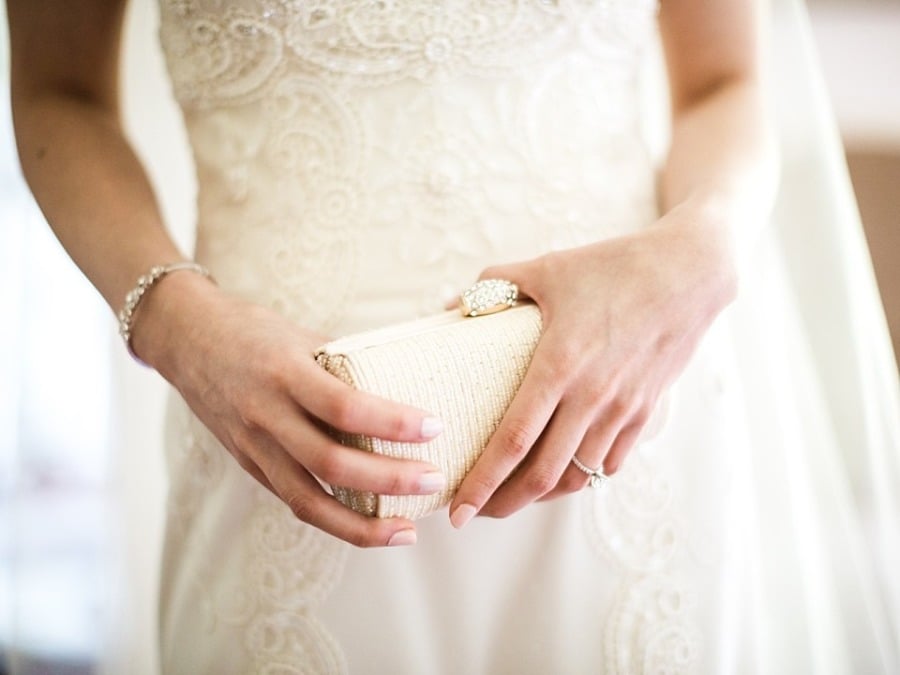 Tip: If posing with your hands feels unnatural, hold something, like your clutch.
Photo by Lauren Fair Photography via Green Wedding Shoes