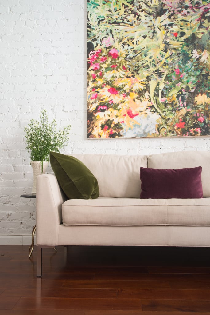 Art, pillows, and natural accents provide color in Julia's gallery-inspired space.