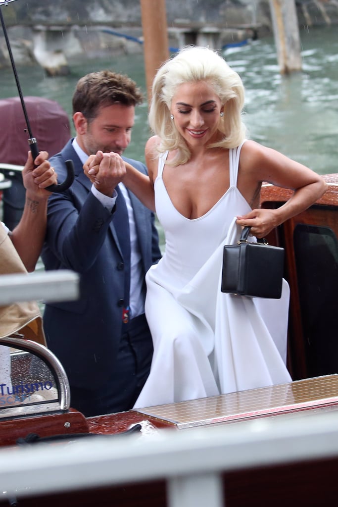 Bradley helped Gaga out of their water taxi as they arrived in style for the Venice Film Festival.