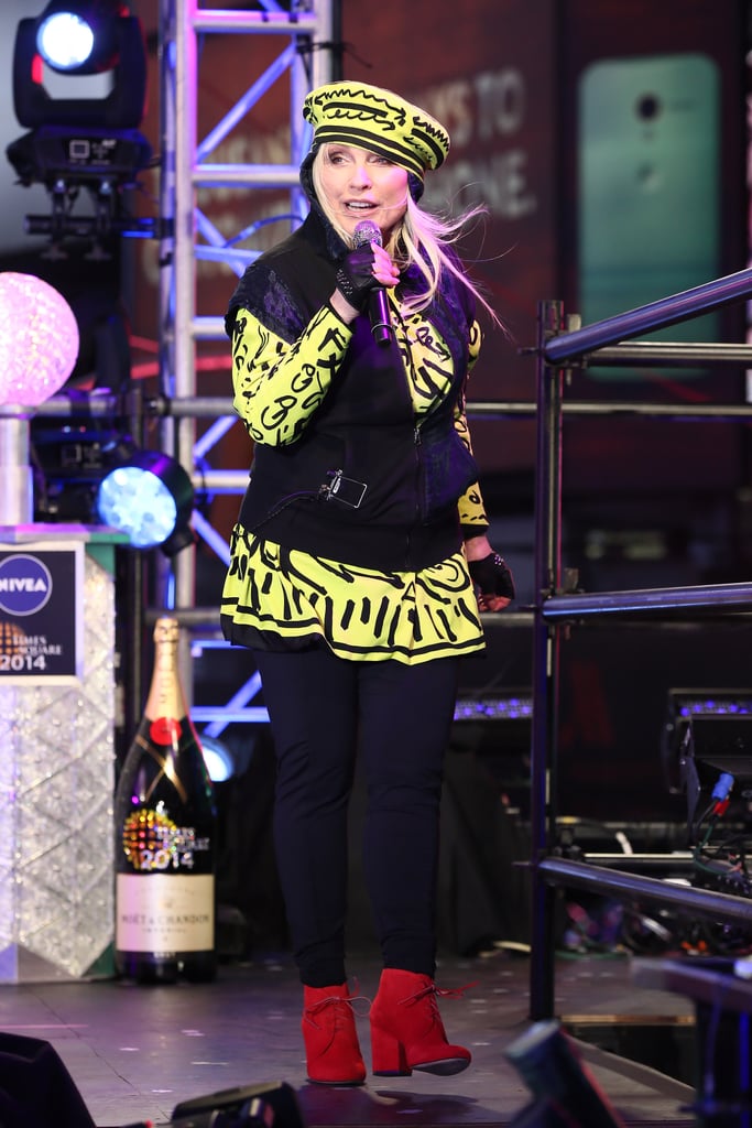 Debby Harry performed in a mostly black outfit punctuated by a printed yellow top and matching hat.
