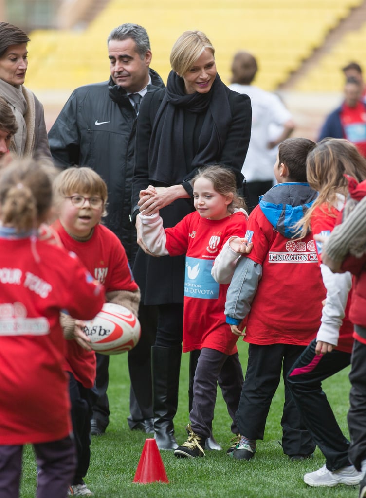 Princess Charlene channeled her sporty side while hanging out with children at the 4th Challenge Sainte-Devote of Rugby in February 2014.